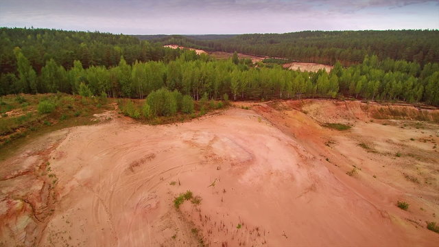 Aerial shot of the sand quarry area in Piusa. The white sands beings excavated from the ground there are trees on the other parts of the area