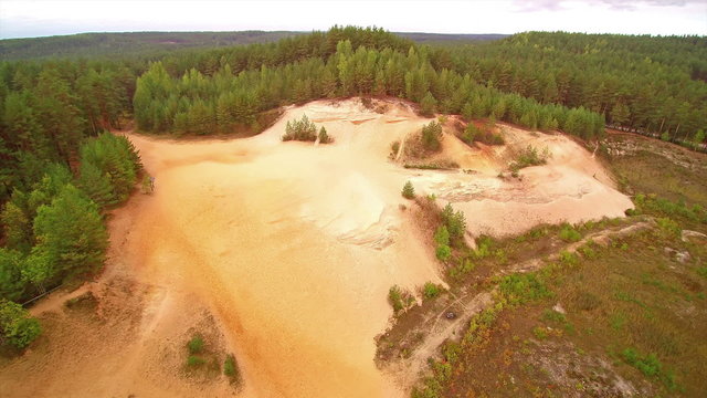 Zoom in look of the white sand quarry area in Piusa Estonia. The white area is being surrounded with lots of trees in the forest