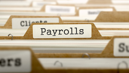 Payrolls Concept with Word on Folder.