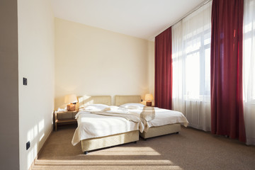 Hotel room interior with two beds