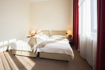 Hotel room interior with two beds