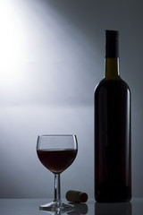 Glass of wine, cork and bottle of wine