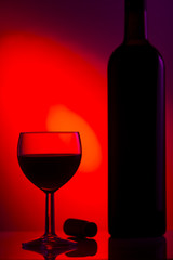 Glass of wine, cork and bottle of wine