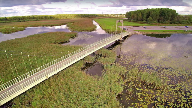 The white long bridge of Roosisaare in voru. Roosisaare (Rose island) Suspension Bridge is a footbridge that was built in 1998 at the end of the Tamula beach promenade