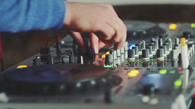 Mixing console time lapse. Hands DJ mixing music at an underground party