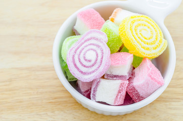 Colorful sweet jellies with sugar in cup.