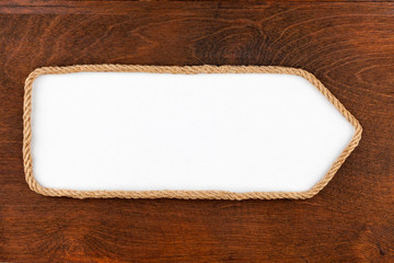 Pointer made of rope with a white background on the wood