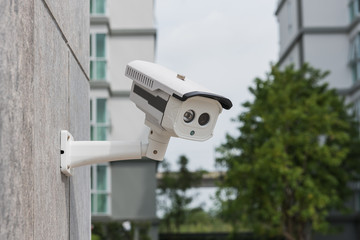 CCTV security camera on stone wall