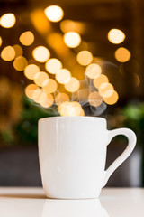 Obraz na płótnie Canvas white coffee cup in coffee shop