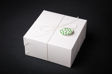 white gift with a bow on a dark background