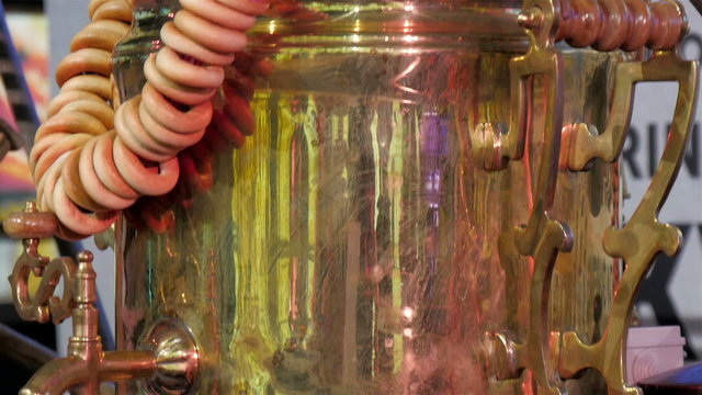The Russian barrel tea in the expo. With hangaing round objects on the barrel one of the display in the EXPO in Italy