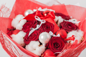 Close-up of Christmas winter bouquet of red rose and cotton in t