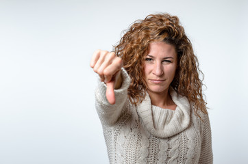 Young woman giving a thumb down gesture