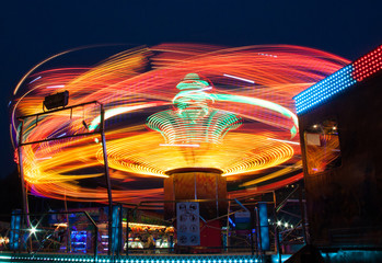 Carousels at night / The visitor amusement park, a very fun and fast carousel for adults. 