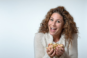 Fun young woman with peanuts in her hands