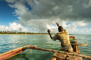 Fisherman in Zanzibar fishing in his boat on a beautiful day