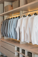 row of shirts hanging on rail