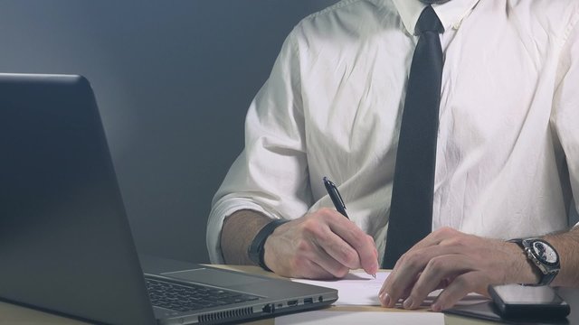 Business calculations, businessman accountant auditing and working in office on laptop computer