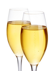Two elegant champagne glasses close-up isolated on a white background. Festive still life.