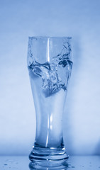 a glass with falling ice
