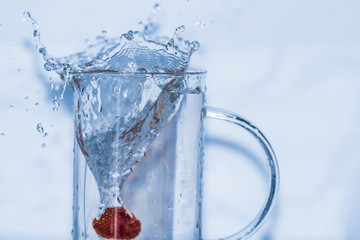 water splashing out of a glass

