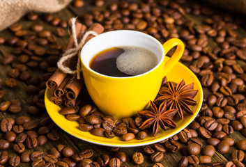 Coffee cup and saucer on a wooden table. Dark background, coffee