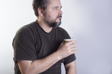 Man with beard holding a cup