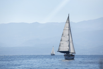 Fototapeta premium Ship yachts with white sails in the Sea. Sailing. Luxury Lifestyle.