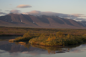 Reflection of mountains in the river. Polar Urals. Sob River. Mountain range Rai-Iz. Russia.
