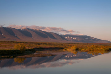 Reflection of mountains in the river. Polar Urals. Sob River. Mountain range Rai-Iz. Russia.