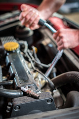 Obraz na płótnie Canvas Starting ignition plug Car mechanic in auto repair service