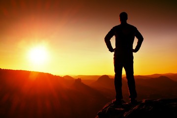 Silhouette of Young Confident and Powerful Man Standing with Hands on Hips, Morning Or Late Day Sun...