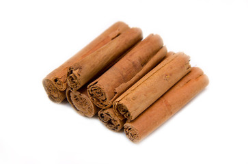 Cinnamon sticks arranged on a white background