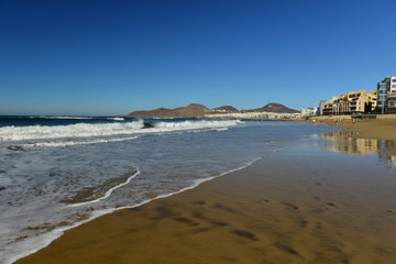 Playa De Las Canteras, Gran Canaria, Spain. Wide angle image of a popular tourism resort beach which people visit for the Winter sun.