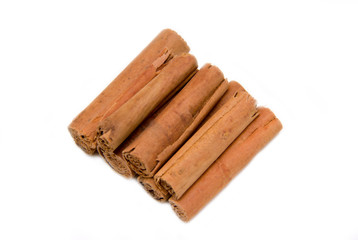 Cinnamon sticks on a white background seen from above