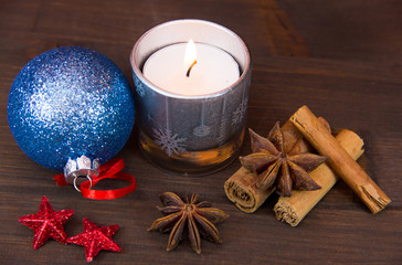 Fototapeta na wymiar Candle and other Christmas themed items on wooden table