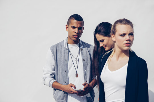 Group Of Three Young People In Front Of White Background