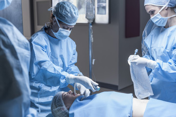 Surgical team preparing patient for operation