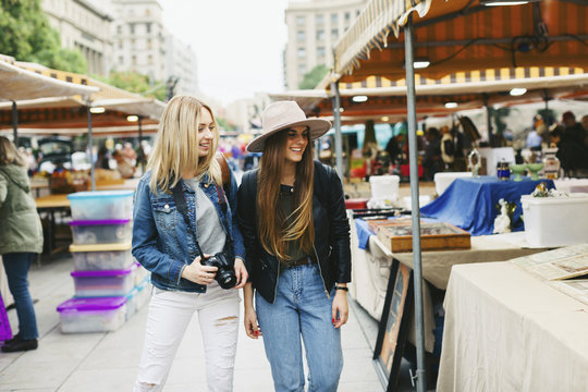 Spain, Barcelona, two young women on flea market