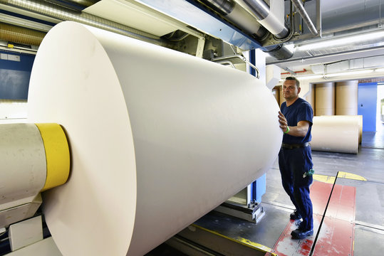 Man working at printing machine in a printing shop