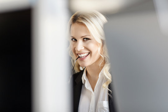 Portrait of smiling blond woman in office