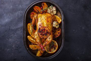 Chicken baked with oranges , cranberries ,garlic .Thanksgiving Dinner. selective focus.