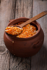 Millet porridge with pumpkin and milk in a clay pot