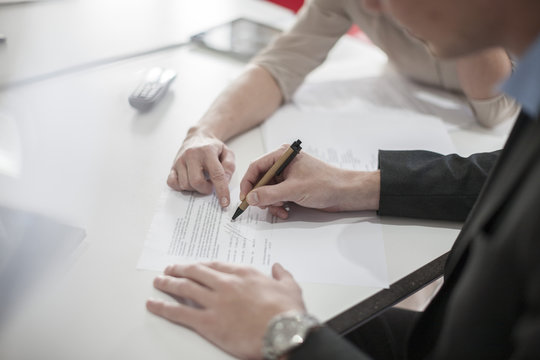 Close-up of man signing a document