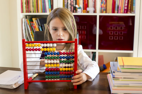 Girl using abacus at home