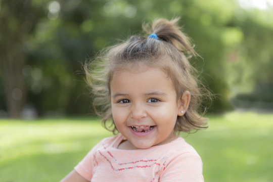 Portrait of smiling little girl in a park