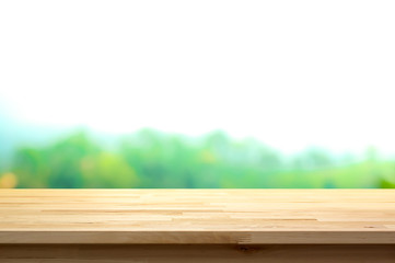 Wood table top on blur natural green background
