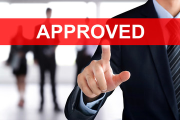 Businessman hand touching APPROVED sign on virtual screen