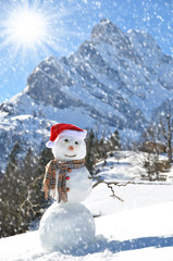 Snowman against Alpine panorama