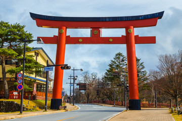 Torii GAte of Futarasan Shrine in front of Lake Chuzenji, Nikko, Japan